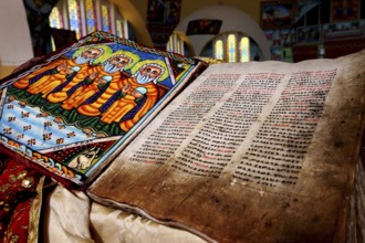 Bible inside St. Mary's Cathedral in Axum shows beautiful stained glass and detailed illuminations,