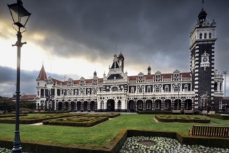 Historic Dunedin railway station with well-kept gardens and dramatic skies, Dunedin, null, New