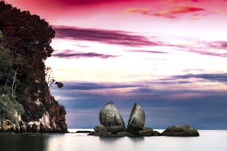 Split Apple Rock under dramatic red sky, Abel Tasman National Park, New Zealand