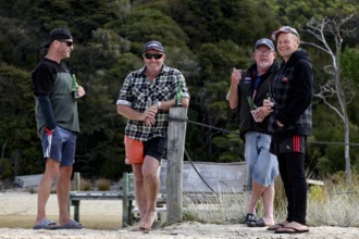 Male group standing on the beach of the Abel Tasman Coast Track, Torrent Bay, Abel Tasman National