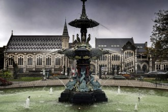 Impressive fountain in front of the Canterbury Museum in Christchurch under cloudy sky,