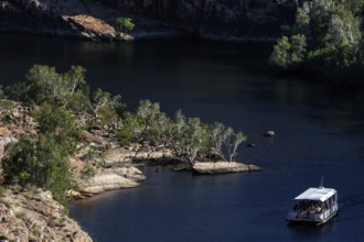 Boating on calm river between rocky landscape at Pat's Lookout in Nitmiluk National Park, Nitmiluk