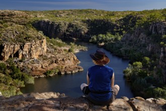 Person sitting on the edge looking at the river in Pat's Lookout, Nitmiluk National Park, Northern