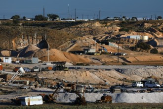 Opal mine in Coober Pedy with machinery in a dry desert landscape, Coober Pedy, South Australia,