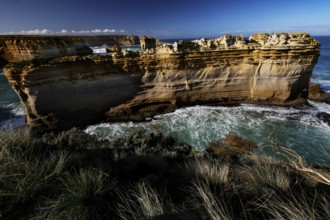 The impressive rock formation The Razorback on the Great Ocean Road surrounded by waves, Great