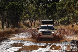Off-road vehicle drives fearlessly through deep water ford on Gibb River Road