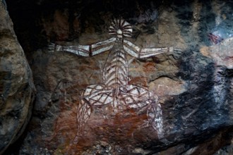 Aboriginal rock painting depicting a mystical figure with outstretched arms, Nourlangie, Northern
