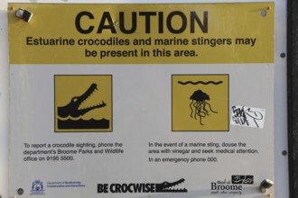 Warning sign on Cable Beach warns of crocodiles and jellyfish in the area, Broome, Western