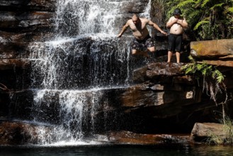 People enjoy refreshment in a waterfall in Galvans Gorge, zero