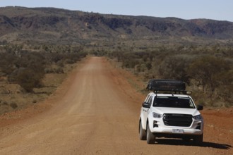 Off-road vehicle on lonely road of Mereenie Loop Road, Mereenie Loop Road, Northern Territory,