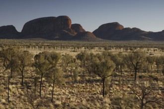 Wide desert-like landscape with distinctive rock formations in the distance, zero