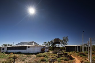Buildings under bright sun in the barren landscape of Old Andado Station, Old Andado Station,