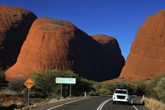Road in the outback leads through the massive red rocks at Kata Tjuta, Kata Tjuta, Northern