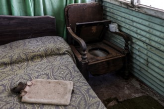 Rustic interior with bed, wooden chair and green curtains, zero