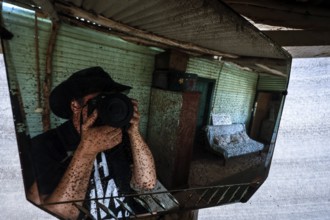 Reflection of a photographer in a rustic interior, zero