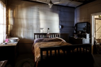 Subdued bedroom with old-fashioned bed and wooden furniture, zero