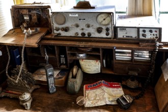 Antique radio on a table with maps and old devices, zero