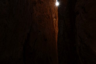 Dark rocky gorge with narrow beam of light in Standley Chasm, zero