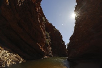 Deep gorge in Simpson Gap with sunbeams over the rocks, Simpson Gap, Northern Territory, Australia