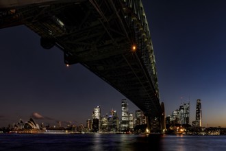 Nighttime view of illuminated Sydney Harbour Bridge and Opera Houses, Sydney, New South Wales,