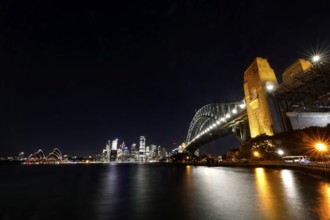 Sydney at night with the impressively illuminated bridge and opera house, Sydney, New South Wales,