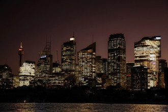 Sydney skyline illuminated at night with reflecting lights on skyscrapers, Sydney, New South Wales,