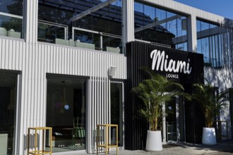 Modern bar with stylish façade and palm trees in front of the entrance, Pärnu, Pärnu County,