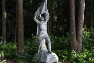 Socialist sculpture in the green forest of Grutas Park in Druskininkai, Druskininkai, Lithuania