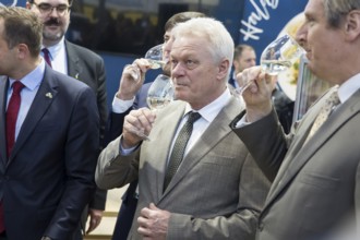 Alios Rainer (Federal Minister of Agriculture, Food and Home Affairs) smells a glass of wine at