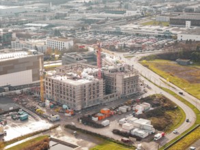 Aerial view of a construction site of a new hospital in an industrial area with buildings and