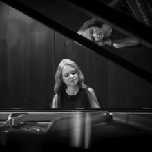 Young woman, pianist playing on a Steinway & Sons grand piano, black and white recording,