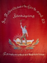 Red flag showing a worker with a torch in front of the rising sun, Tändsticksmuseet match museum or