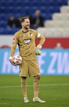 Goalkeeper Oliver Baumann TSG 1899 Hoffenheim (01) with match ball smiles PreZero Arena, Sinsheim,