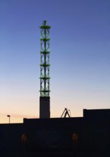 Illuminated municipal utility tower of Stadtwerke Duisburg at dusk, Duisburg, Ruhr area, North
