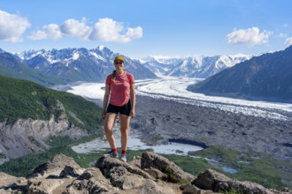 Young woman in front of impressive mountain landscape with Matanuska glacier and glaciated mountain