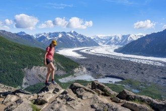 Young woman enjoying the view, view of impressive mountain landscape with Matanuska glacier and