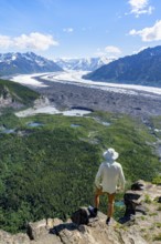 Young man enjoying the view, view of impressive mountain landscape with Matanuska glacier and