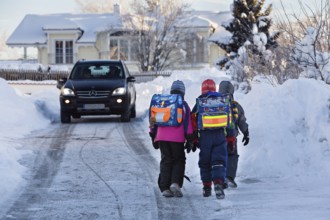 School children on their way to school in winter with lots of snow, Upper Bavaria, Germany