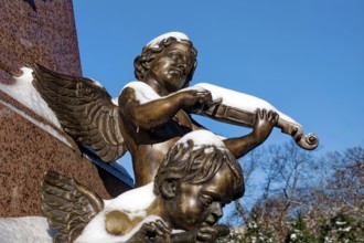 An angel playing the violin, figure at the Felix Mendessohn Bartholdy monument in winter with snow,
