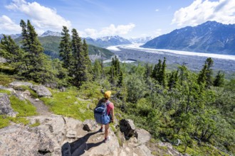 Young woman enjoying the view, view of impressive mountain landscape with Matanuska glacier and