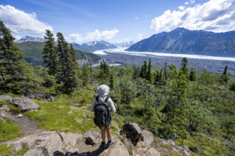 Young man enjoying the view, view of impressive mountain landscape with Matanuska glacier and