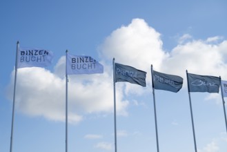 Flags against a blue sky with clouds, writing Binzer Bay and Prora, Binz, seaside resort, Rügen