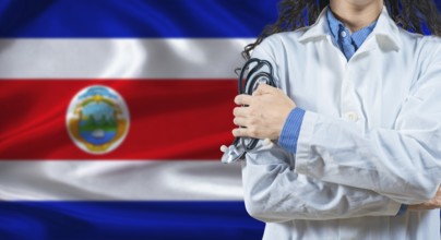 Healthcare professional with Costa Rica flag background. Professional doctor holding stethoscope on