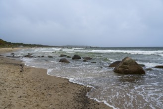 Boulders and waves on the coast, sandy beach, Baltic resort Göhren, Baltic Sea, Rügen island,