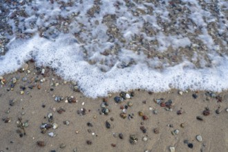 Pebbles on the coast surrounded by water, view from above, Baltic Sea, Rügen island,