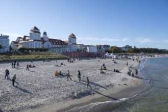 Tourists on the beach in autumn, spa hotel, Binz, seaside resort, Rügen island, Baltic Sea,