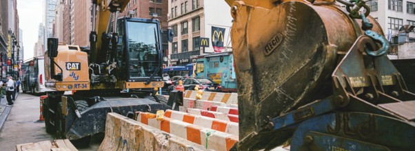 Excavator in front of the New Yorker Hotel, New York, USA