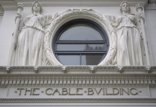 Two female sculptures above the entrance to the historic Cable Building, built in 1894 in Beaux