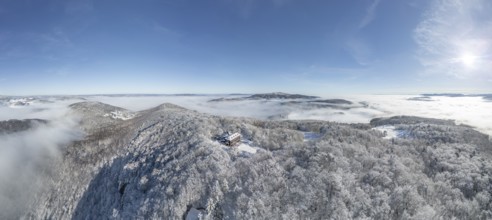 Aerial view of snowy stone walls with shelter and fog in the valley, Schwarzensee, Weissenbach an