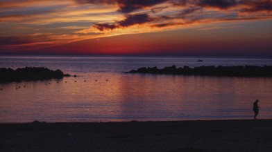 Twilight landscape with sunset, dramatic sky and silhouette of people on the beach (Playa Flamingo)